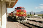 Santa Fe C44-9W #655 (with C40-8W #807, B40-8W #547 & GP60M #125) blasts past the depot with another westbound intermodal train 